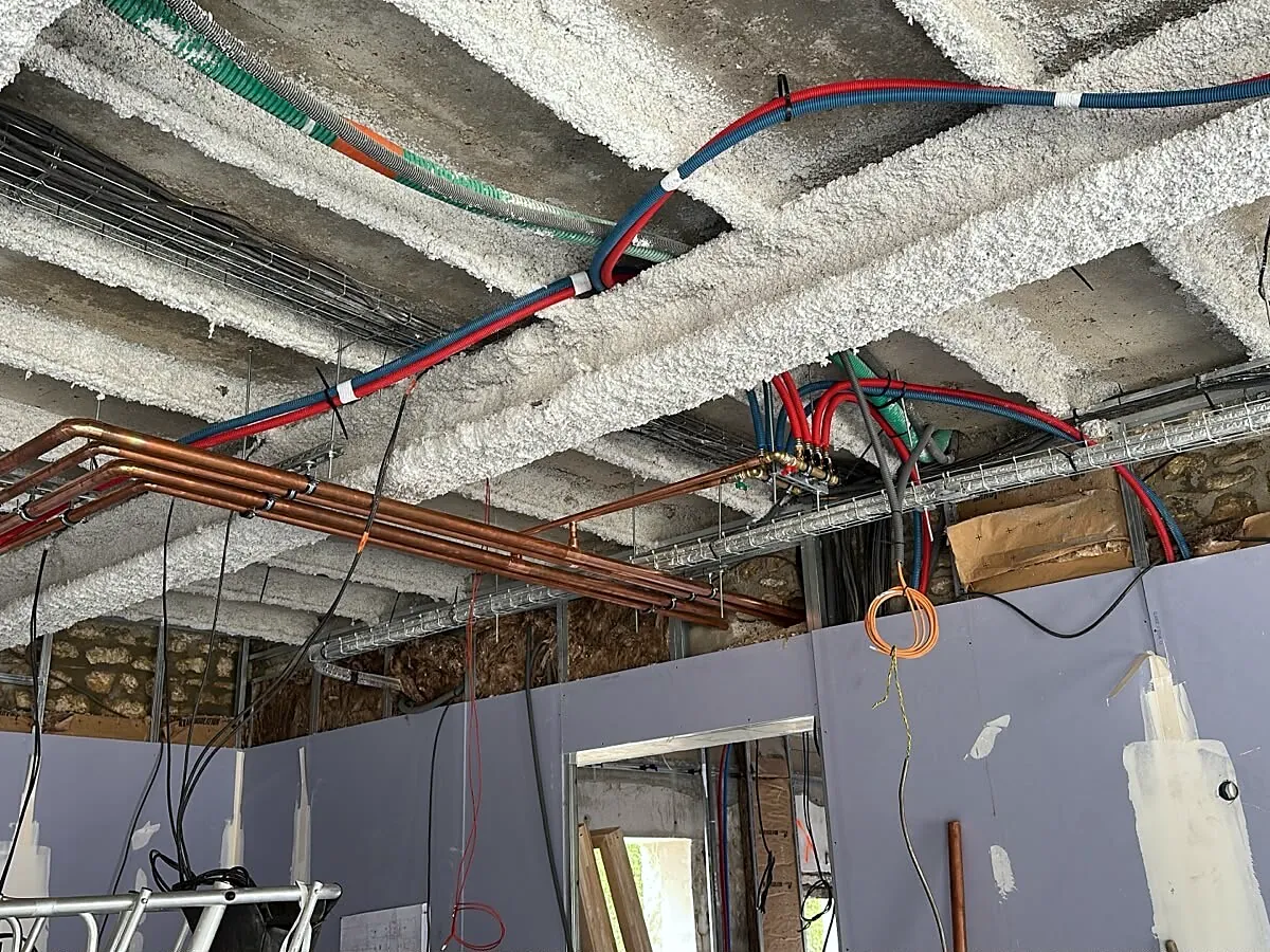 Réseaux en cuivre posés sous le plafond pendant la rénovation, août 2026